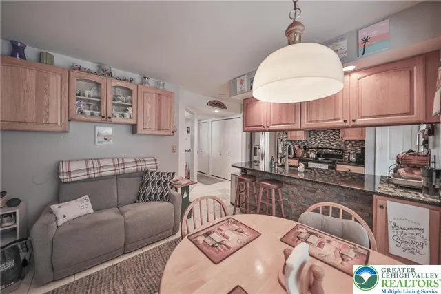 a living room with furniture a chandelier and a wooden floor