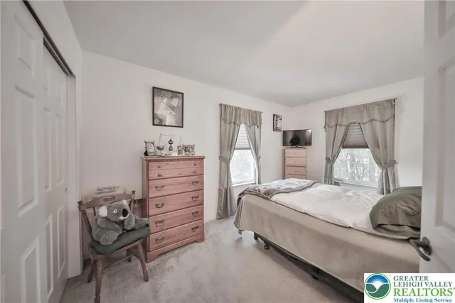 a bedroom with a bed and a chair