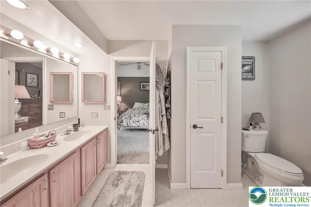 a en suite bathroom with a sink double vanity and shower