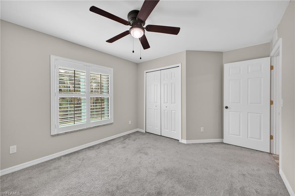 8422 Cardinal Road Fort Myers, FL 33967 - Photo 16 of 24 Unfurnished bedroom featuring carpet flooring, ceiling fan, and a closet