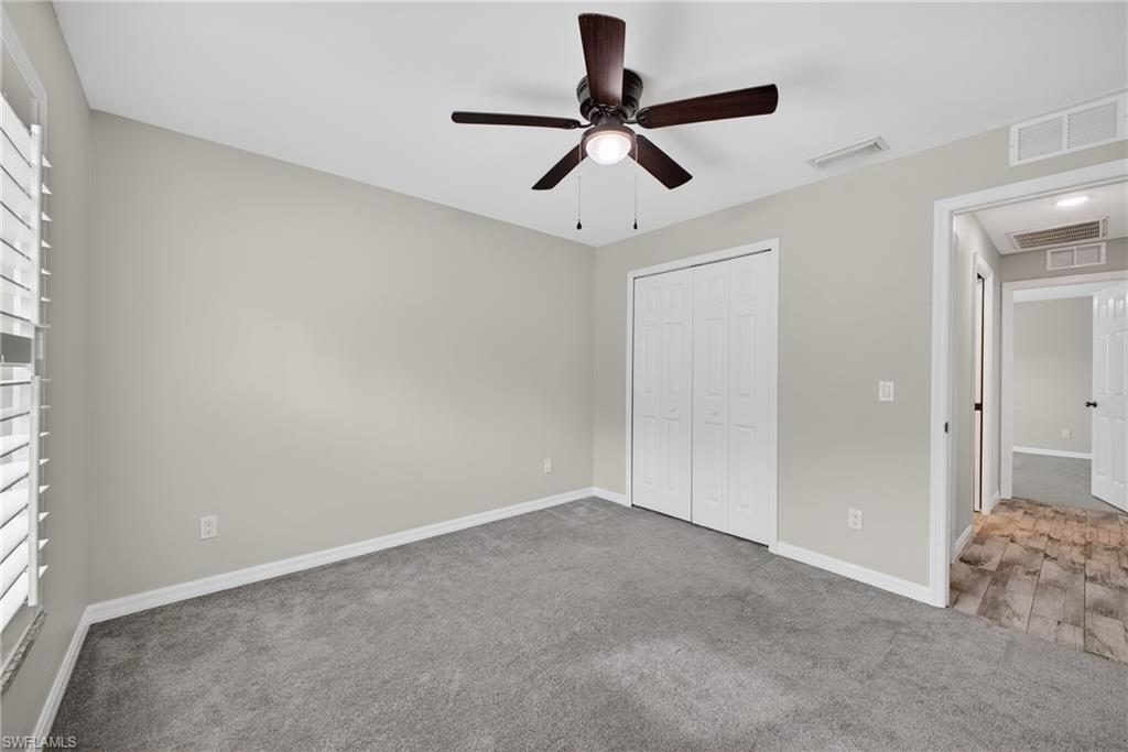 8422 Cardinal Road Fort Myers, FL 33967 - Photo 18 of 24 Unfurnished bedroom with carpet floors, a closet, and ceiling fan