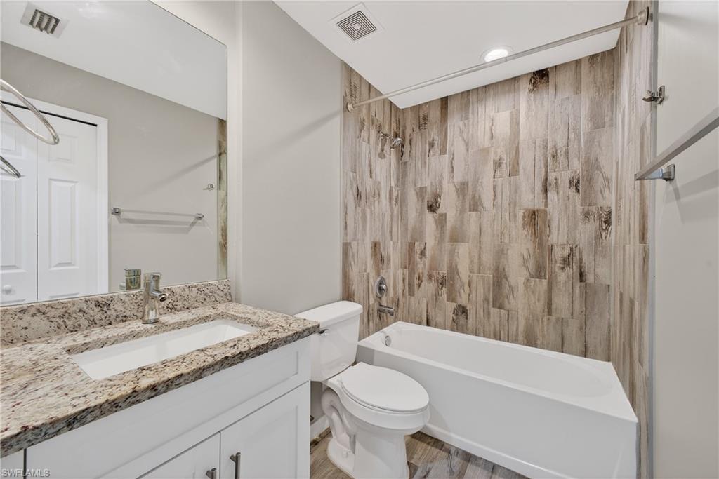 8422 Cardinal Road Fort Myers, FL 33967 - Photo 19 of 24 Bathroom featuring vanity, shower / washtub combination, and light wood-type flooring