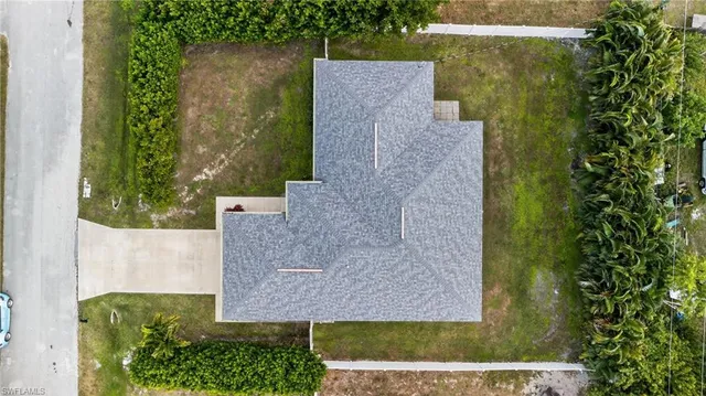 an aerial view of a house with a yard