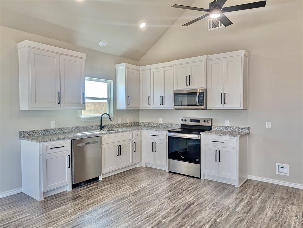 300 Rike Road Mabank, TX 75147 - Photo 3 of 18 a kitchen with granite countertop white cabinets and appliances