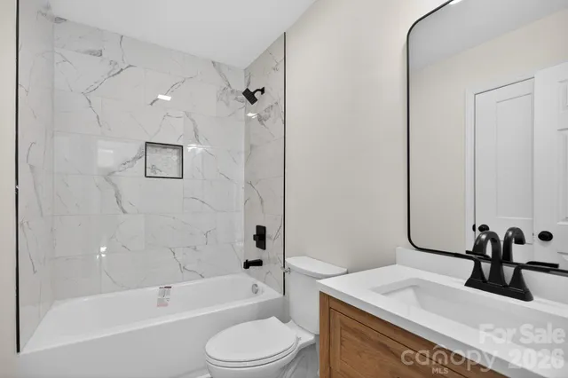 a bathroom with a sink a toilet and a bathtub