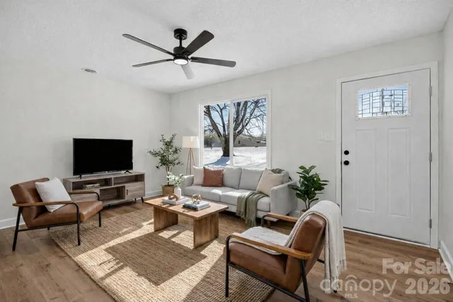 a living room with furniture a rug and a flat screen tv