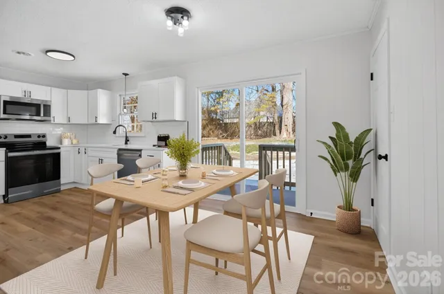 a view of a dining room with furniture window and wooden floor