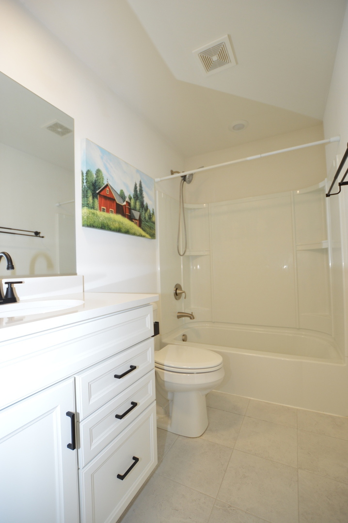1029 Draper Road McHenry, IL 60050 - Photo 20 of 30 a bathroom with a double vanity sink toilet and shower