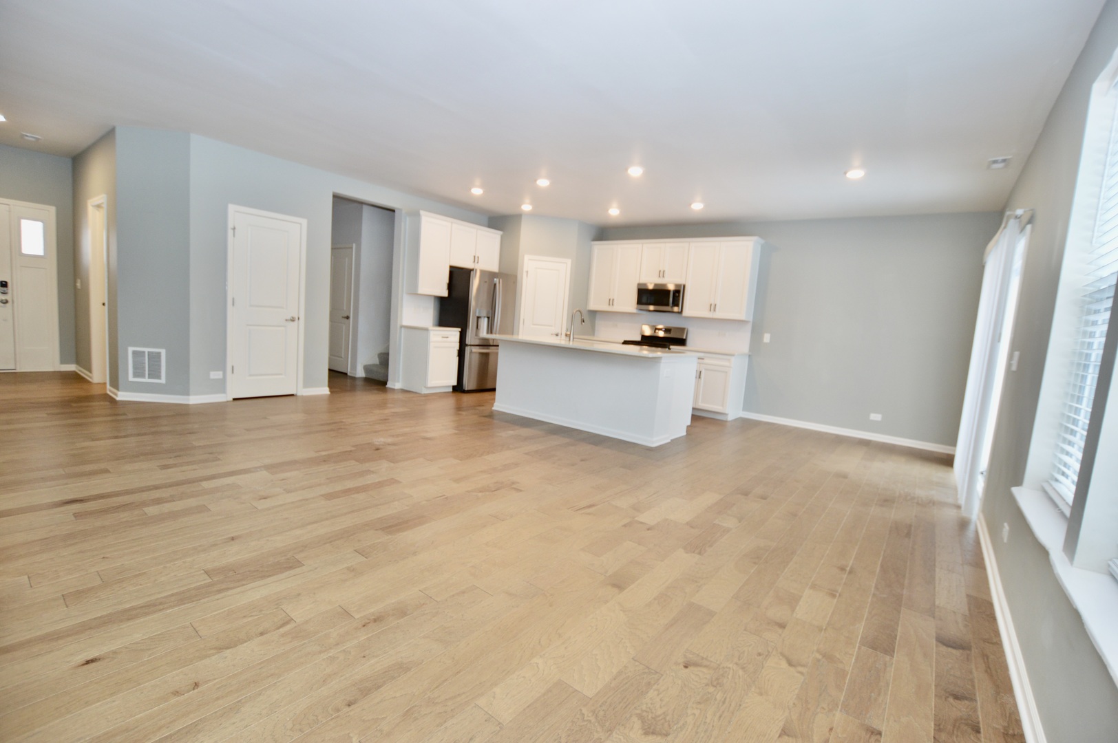1029 Draper Road McHenry, IL 60050 - Photo 5 of 30 a view of an empty room with kitchen and window