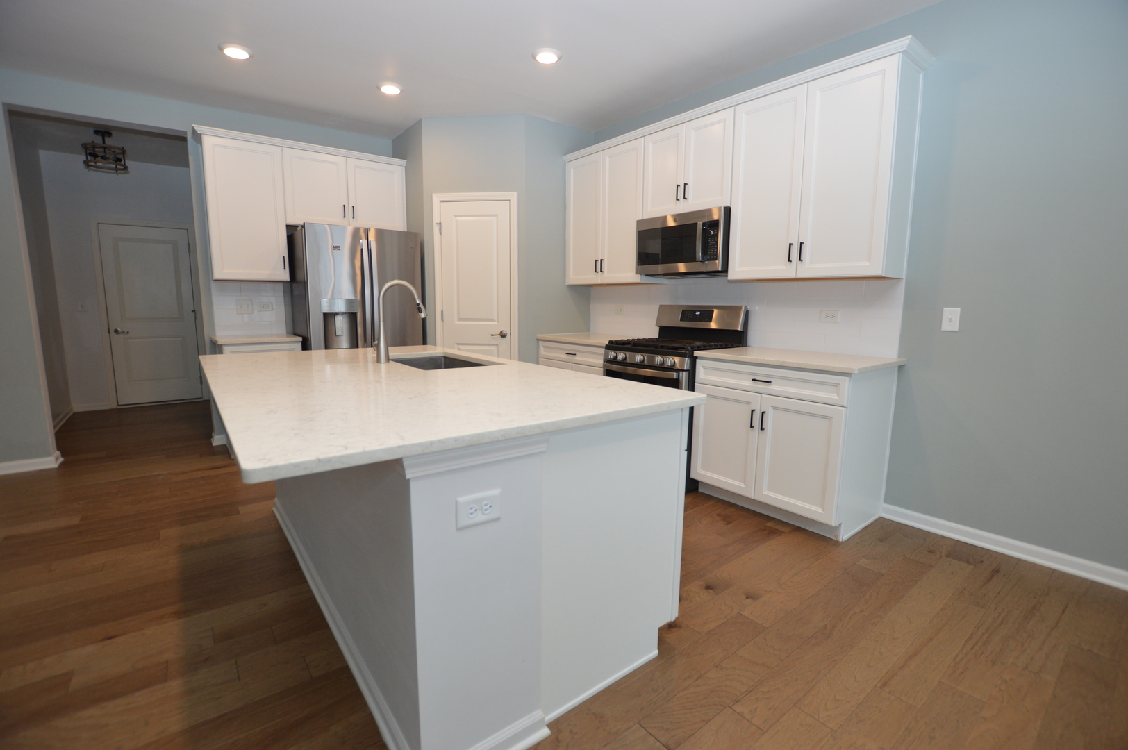 1029 Draper Road McHenry, IL 60050 - Photo 6 of 30 a kitchen with stainless steel appliances a stove refrigerator sink and microwave