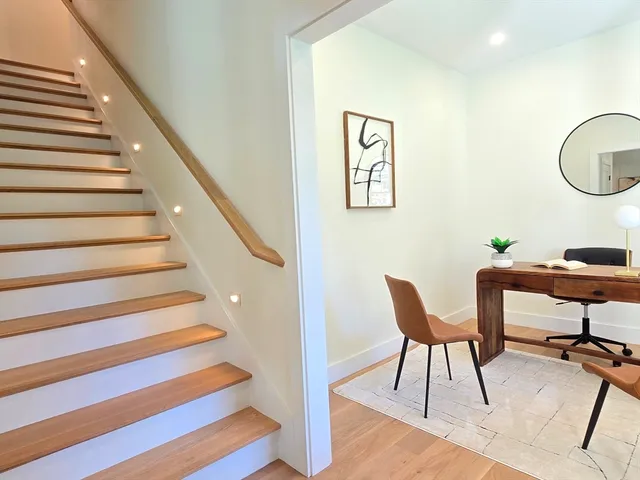 a view of a hallway with wooden floor and entryway