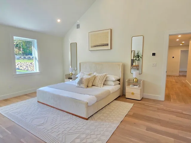 a bedroom with a large bed and a large window