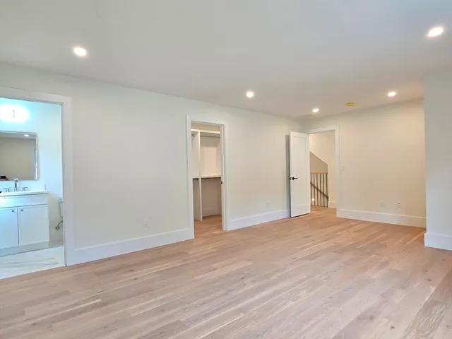 a room with walk in closet and wooden floor