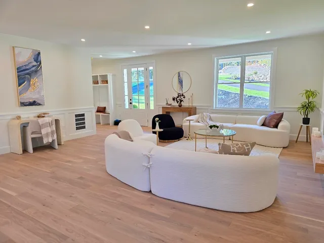 a living room with furniture and a fireplace