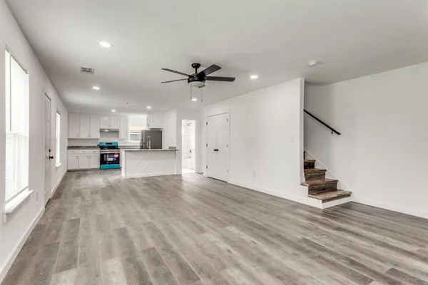 a view of kitchen with sink and refrigerator