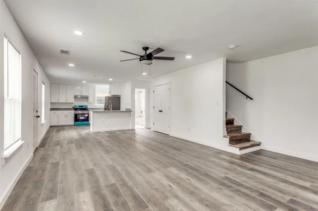 a view of kitchen with sink and refrigerator