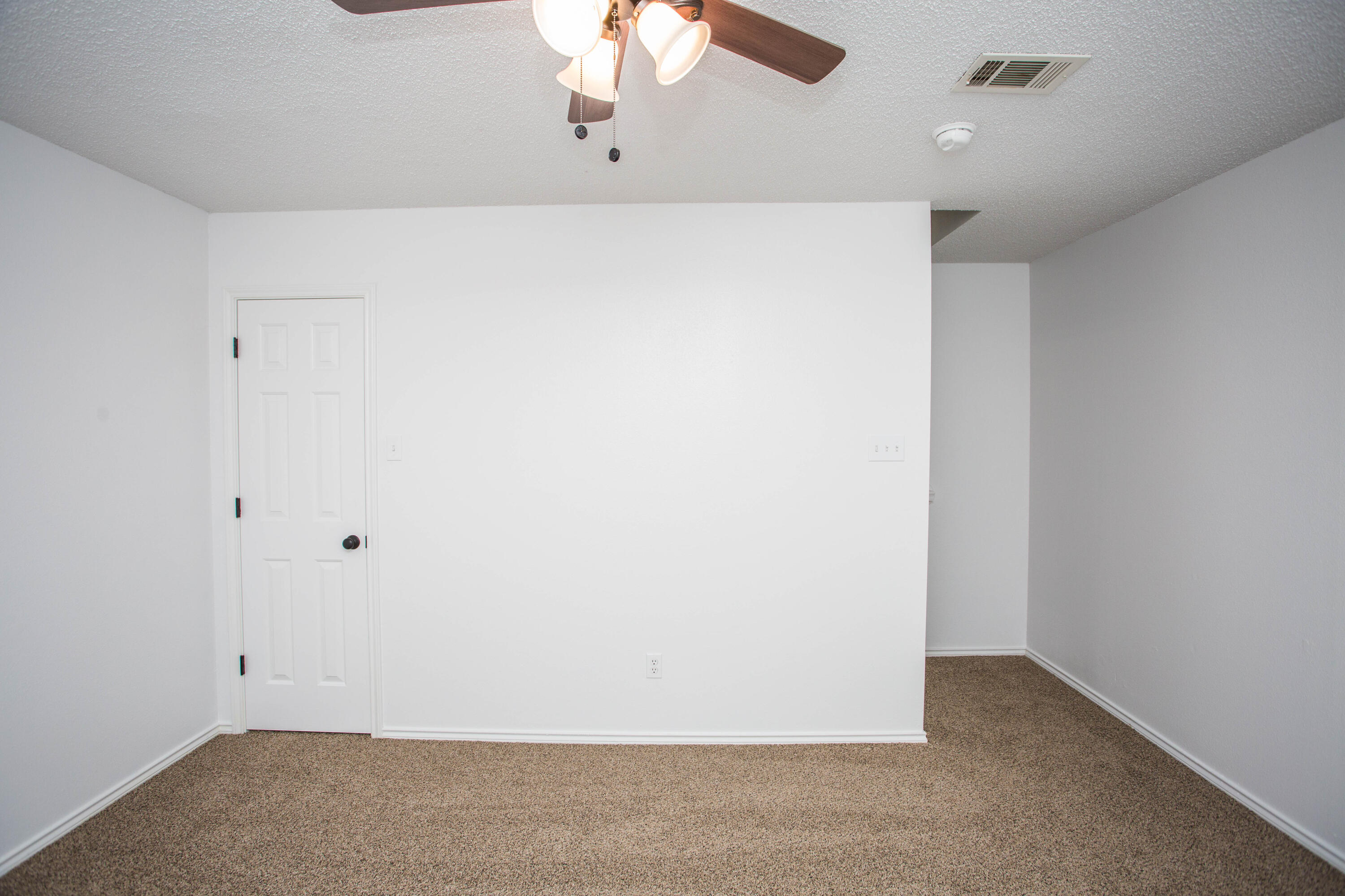 1822 79th Street Lubbock, TX 79423 - Photo 11 of 35 an empty room with a chandelier fan