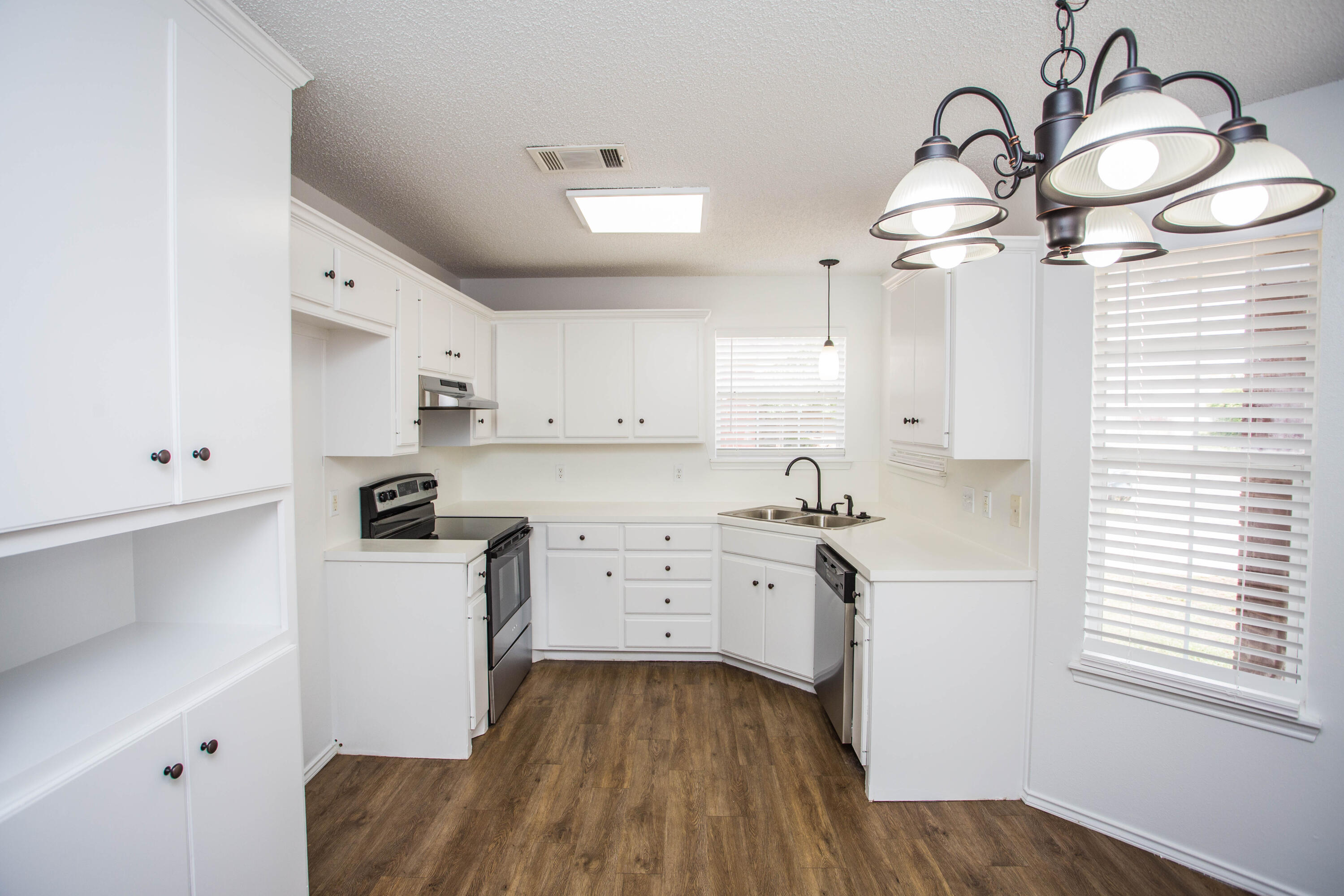 1822 79th Street Lubbock, TX 79423 - Photo 14 of 35 a kitchen with cabinets a sink and appliances