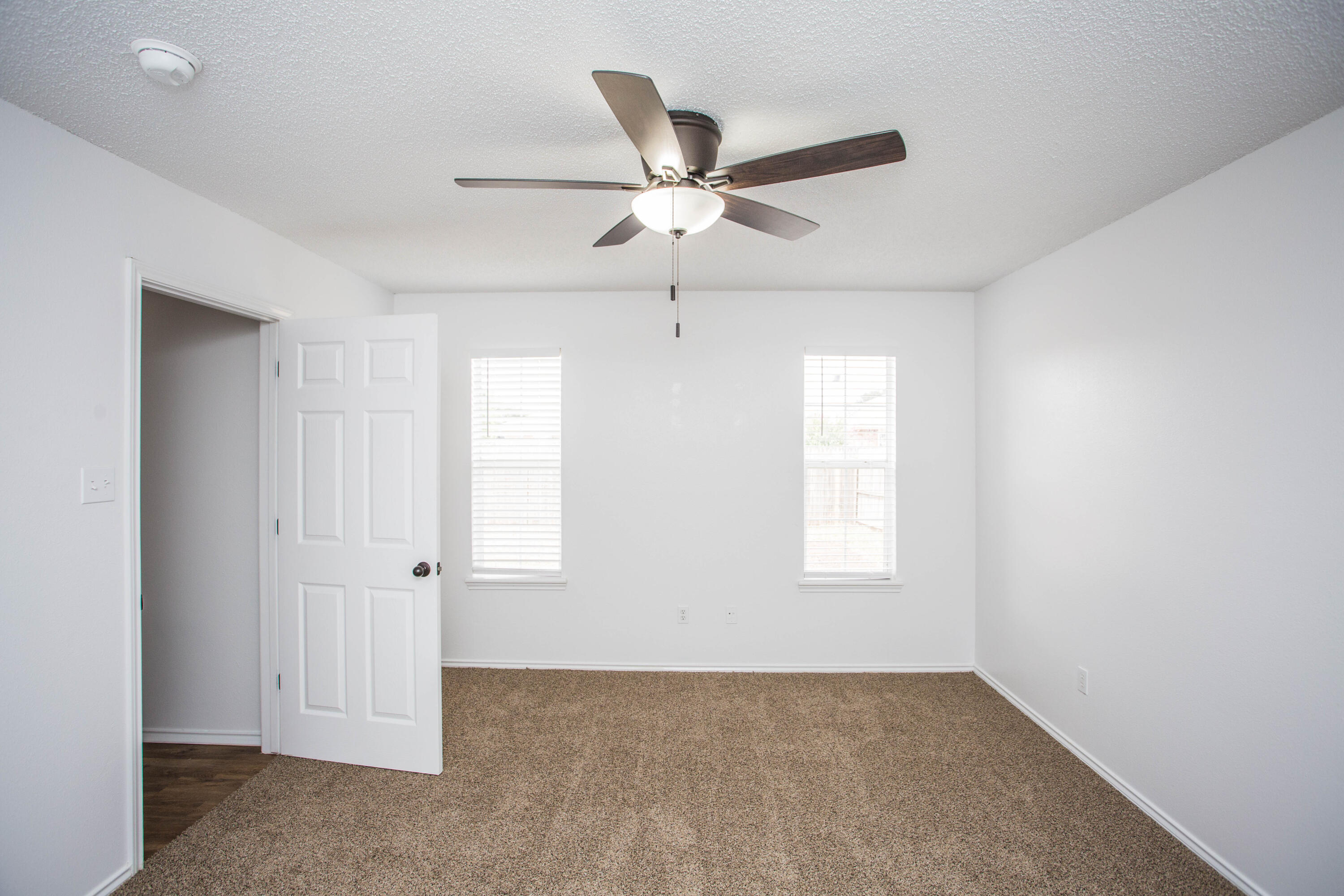 1822 79th Street Lubbock, TX 79423 - Photo 20 of 35 an empty room with windows and fan