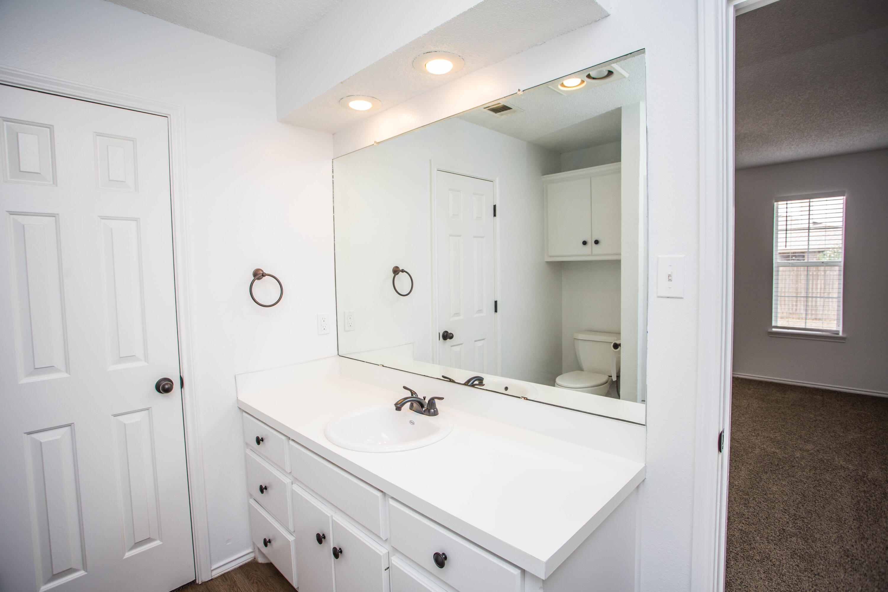 1822 79th Street Lubbock, TX 79423 - Photo 23 of 35 a bathroom with a sink a mirror and a shower