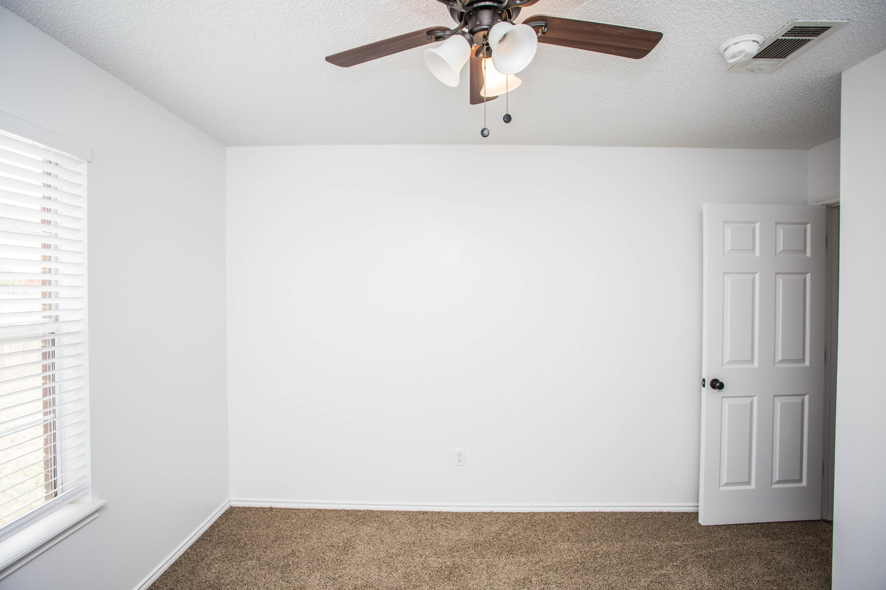 1822 79th Street Lubbock, TX 79423 - Photo 25 of 35 a view of a room with a window and a ceiling fan