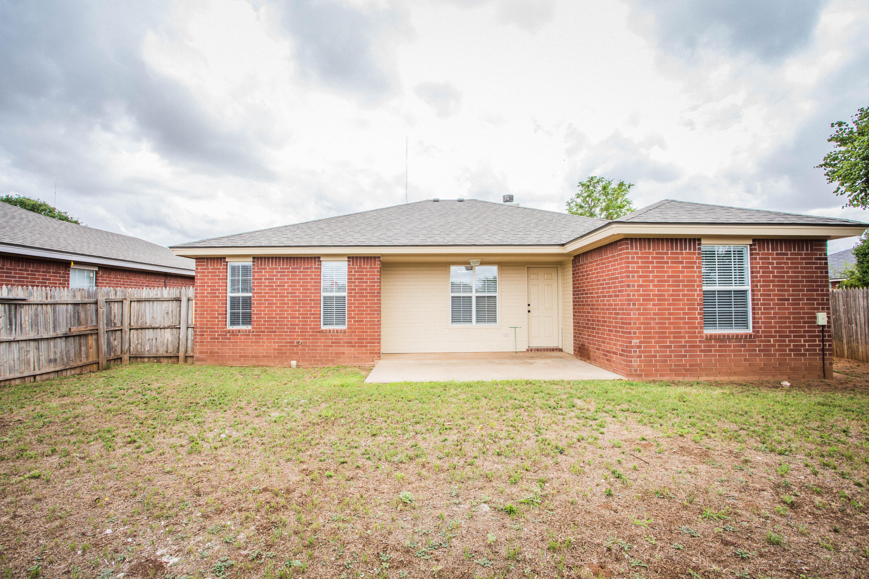 1822 79th Street Lubbock, TX 79423 - Photo 32 of 35 a front view of a house with a yard and garage