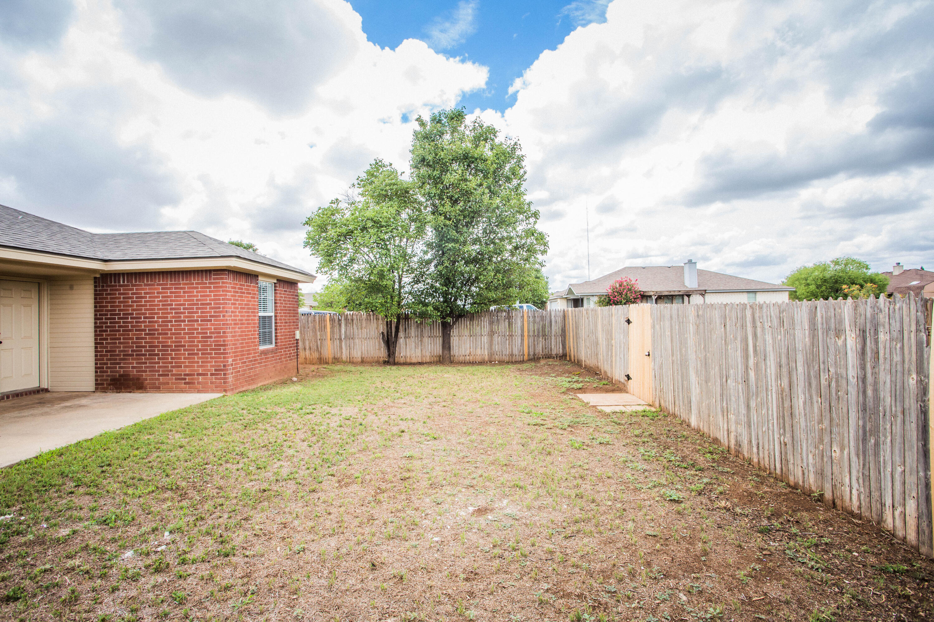 1822 79th Street Lubbock, TX 79423 - Photo 35 of 35 a backyard of a house with wooden fence