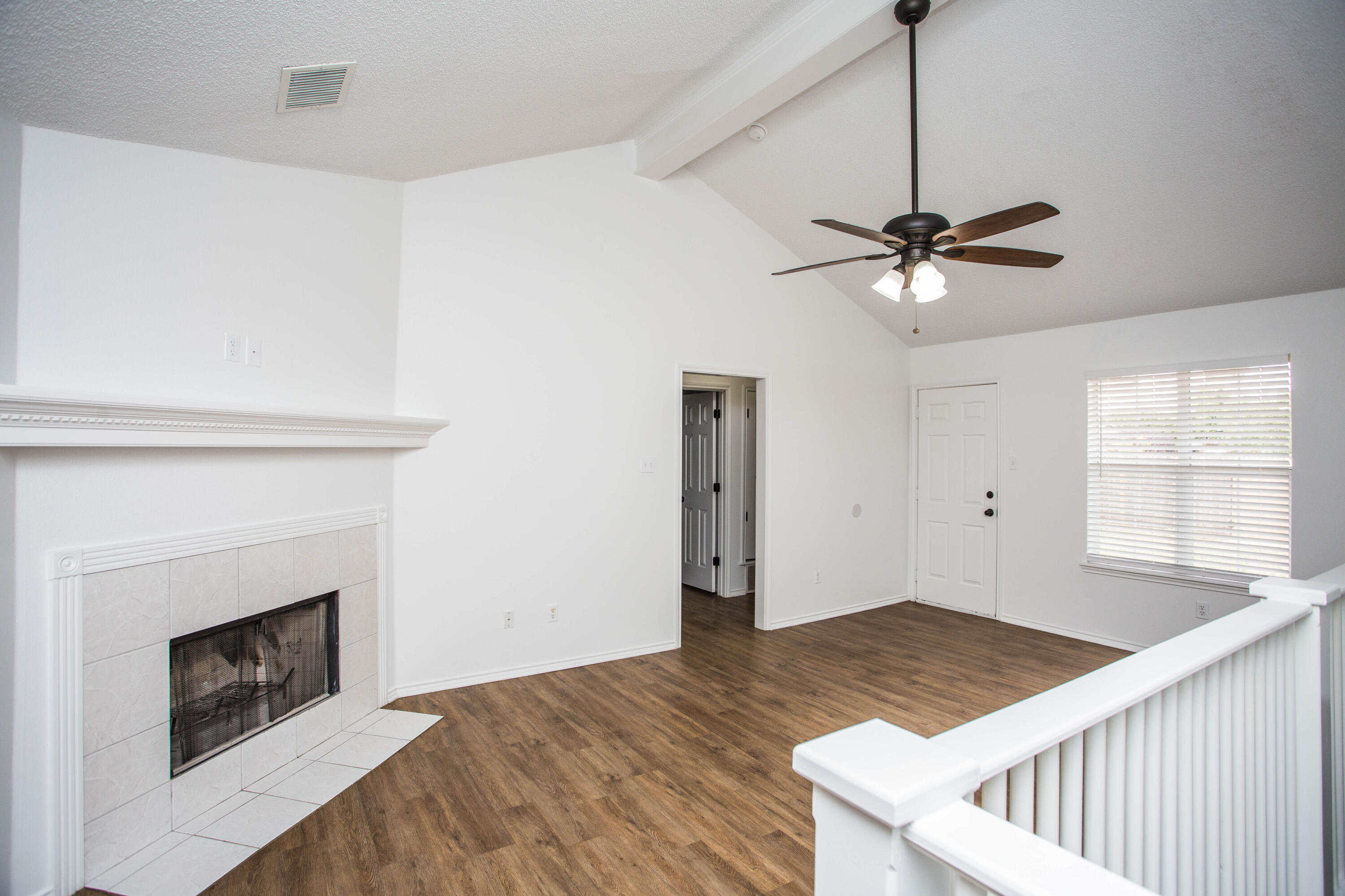 1822 79th Street Lubbock, TX 79423 - Photo 5 of 35 a view of an empty room with chandelier fan and fire place