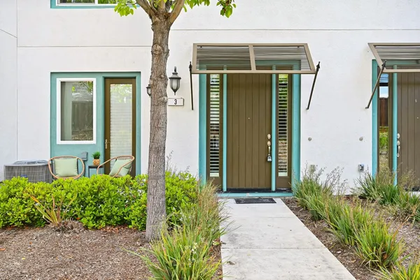 front view of a house with potted plants
