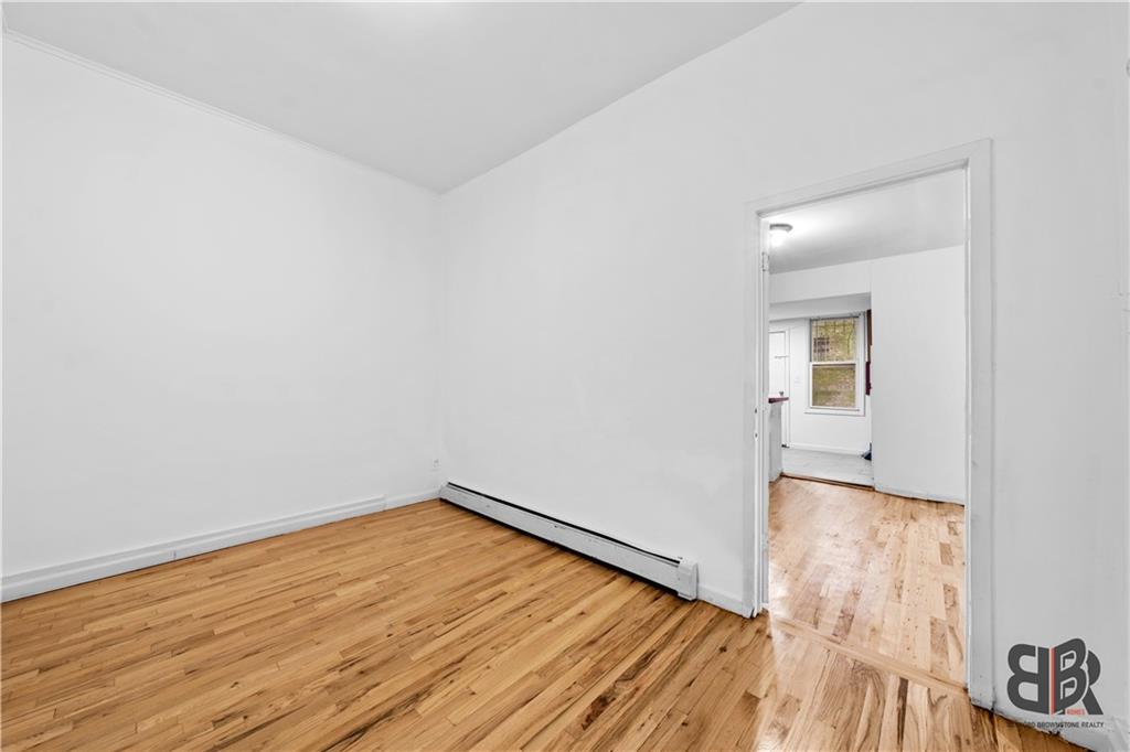 284 MacDougal Street Brooklyn, NY 11233 - Photo 11 of 23 an empty room with wooden floor and windows