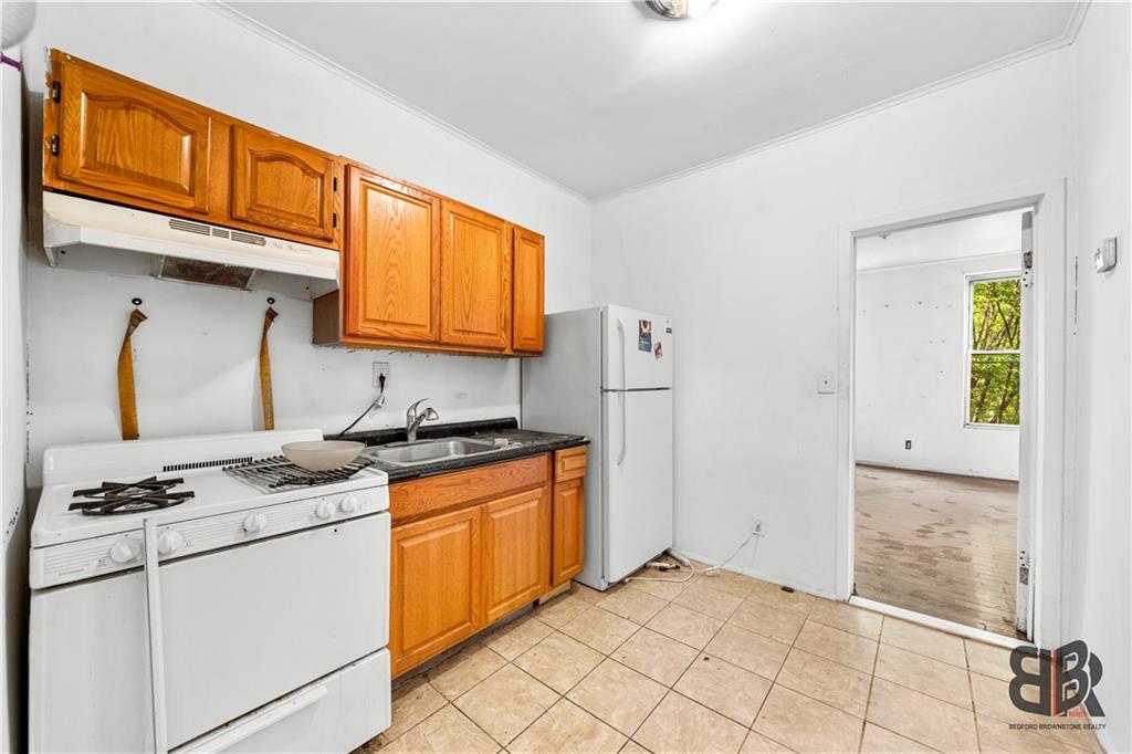 284 MacDougal Street Brooklyn, NY 11233 - Photo 16 of 23 a kitchen with stainless steel appliances granite countertop a stove a sink and a refrigerator