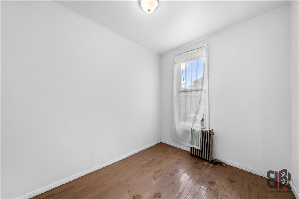 284 MacDougal Street Brooklyn, NY 11233 - Photo 17 of 23 an empty room with wooden floor and windows