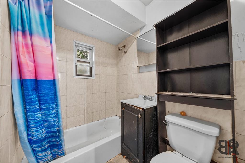 284 MacDougal Street Brooklyn, NY 11233 - Photo 18 of 23 a bathroom with a toilet and a bathtub