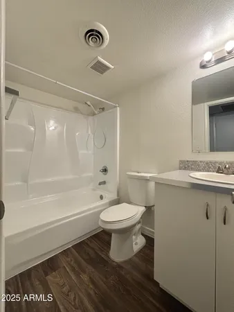 a bathroom with a toilet a sink and bathtub