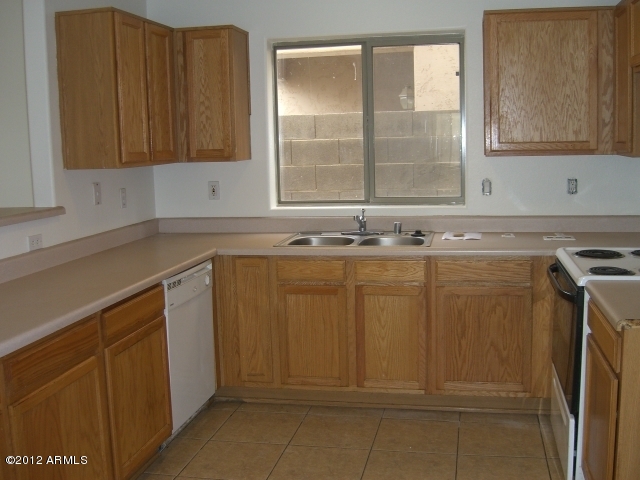 10422 East Bonnell Street Apache Junction, AZ 85120 - Photo 2 of 15 a bathroom with a sink a washer and dryer