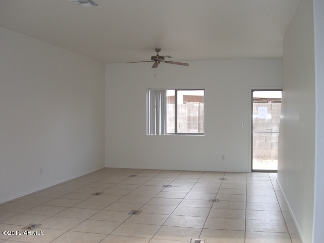 10422 East Bonnell Street Apache Junction, AZ 85120 - Photo 3 of 15 an empty room with windows and fan
