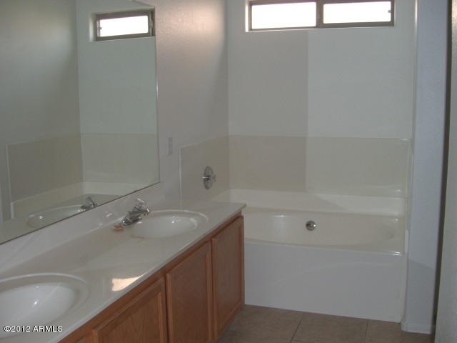10422 East Bonnell Street Apache Junction, AZ 85120 - Photo 4 of 15 a bathroom with a sink a toilet and shower