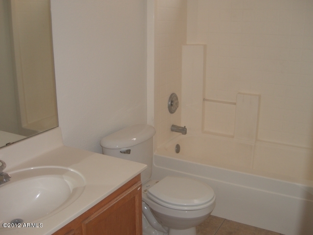 10422 East Bonnell Street Apache Junction, AZ 85120 - Photo 6 of 15 a bathroom with a sink a toilet and shower
