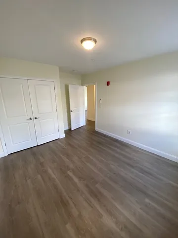 a view of an empty room and wooden floor