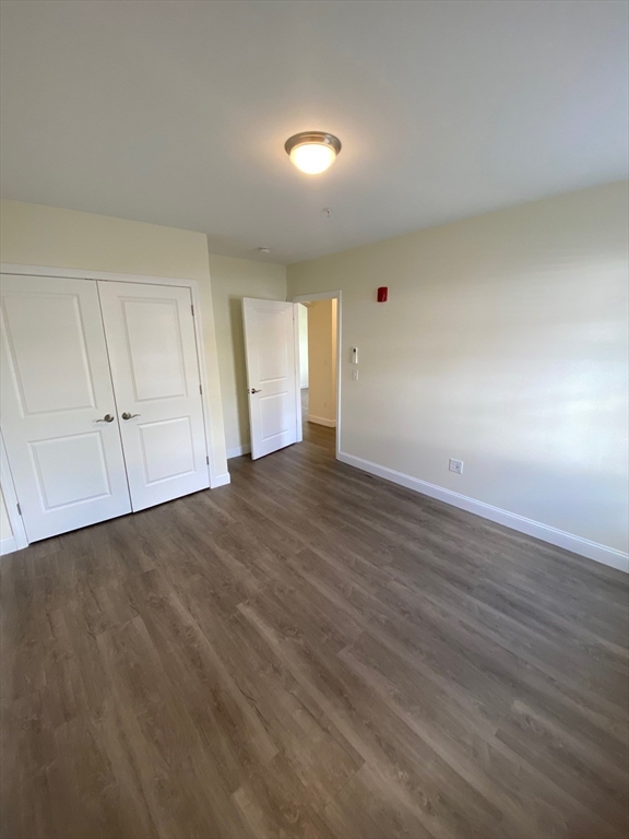 47 Saunders Street, Unit 47 North Andover, MA 01845 - Photo 7 of 11 a view of an empty room and wooden floor