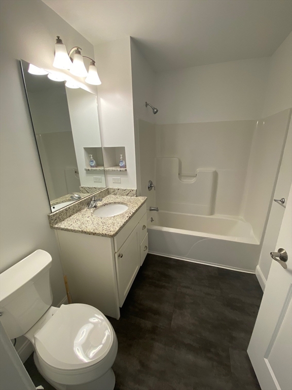 47 Saunders Street, Unit 47 North Andover, MA 01845 - Photo 10 of 11 a bathroom with a granite countertop sink mirror vanity and toilet