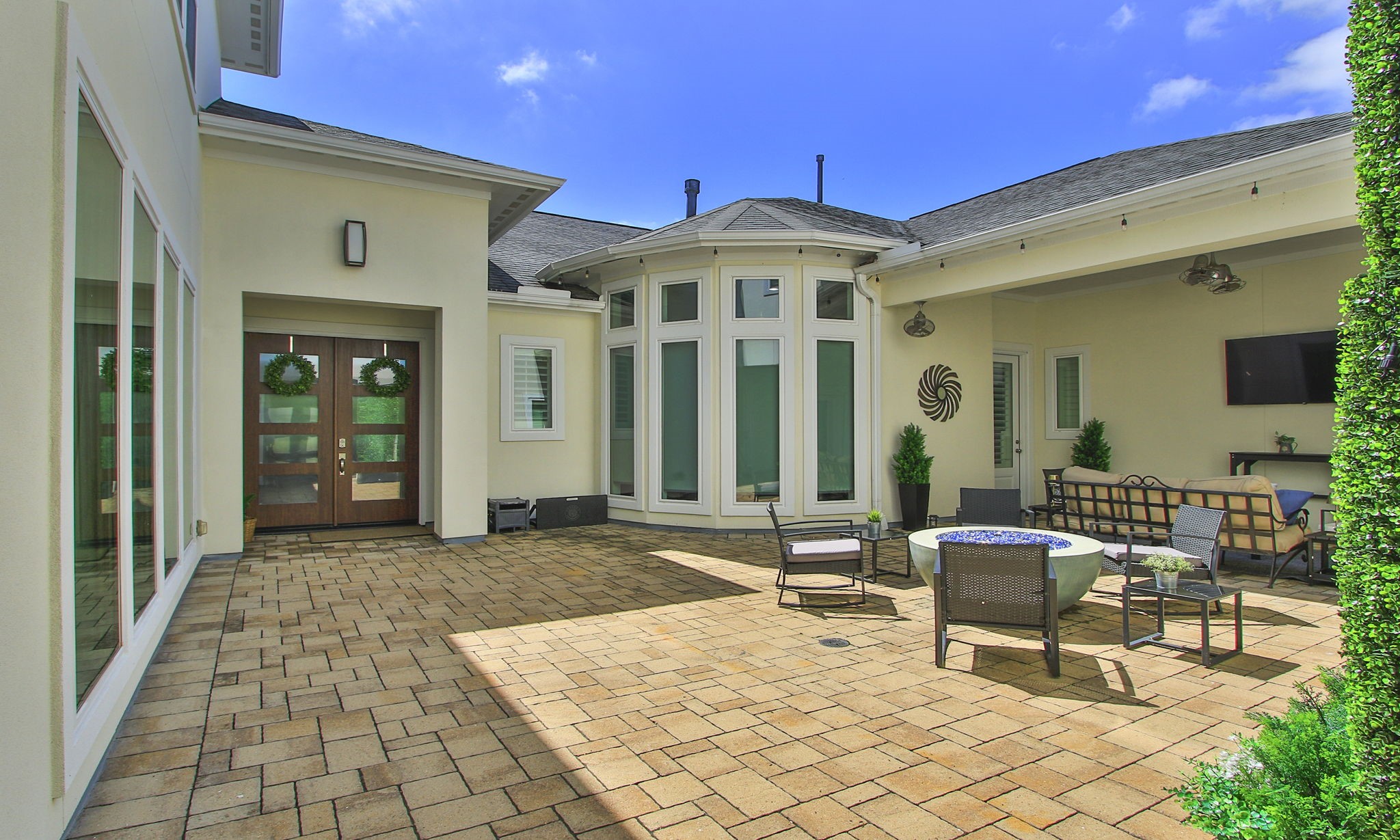 28518 Hoffman Spring Lane Fulshear, TX 77441 - Photo 4 of 50 Step into the open-air courtyard and be welcomed into a private outdoor retreat perfect for entertaining and everyday enjoyment.