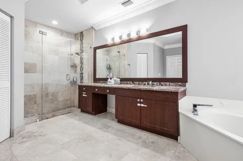 a spacious bathroom with a granite countertop sink and a mirror