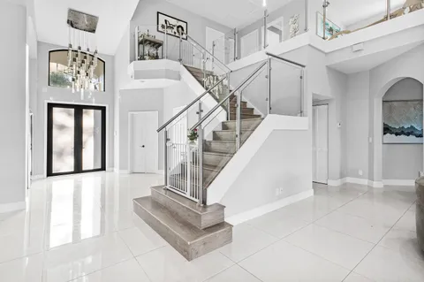 a kitchen with white cabinets and window
