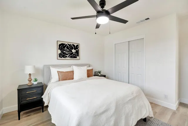a bedroom with a bed and a chandelier