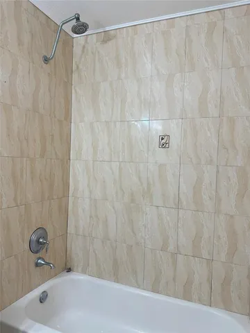 a bathroom with a shower and a sink