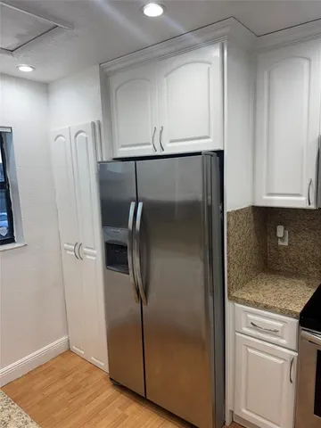 a kitchen with metallic refrigerator freezer and a dishwasher