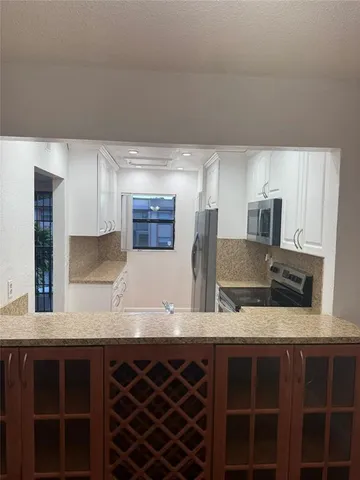 a kitchen with stainless steel appliances a sink and a refrigerator