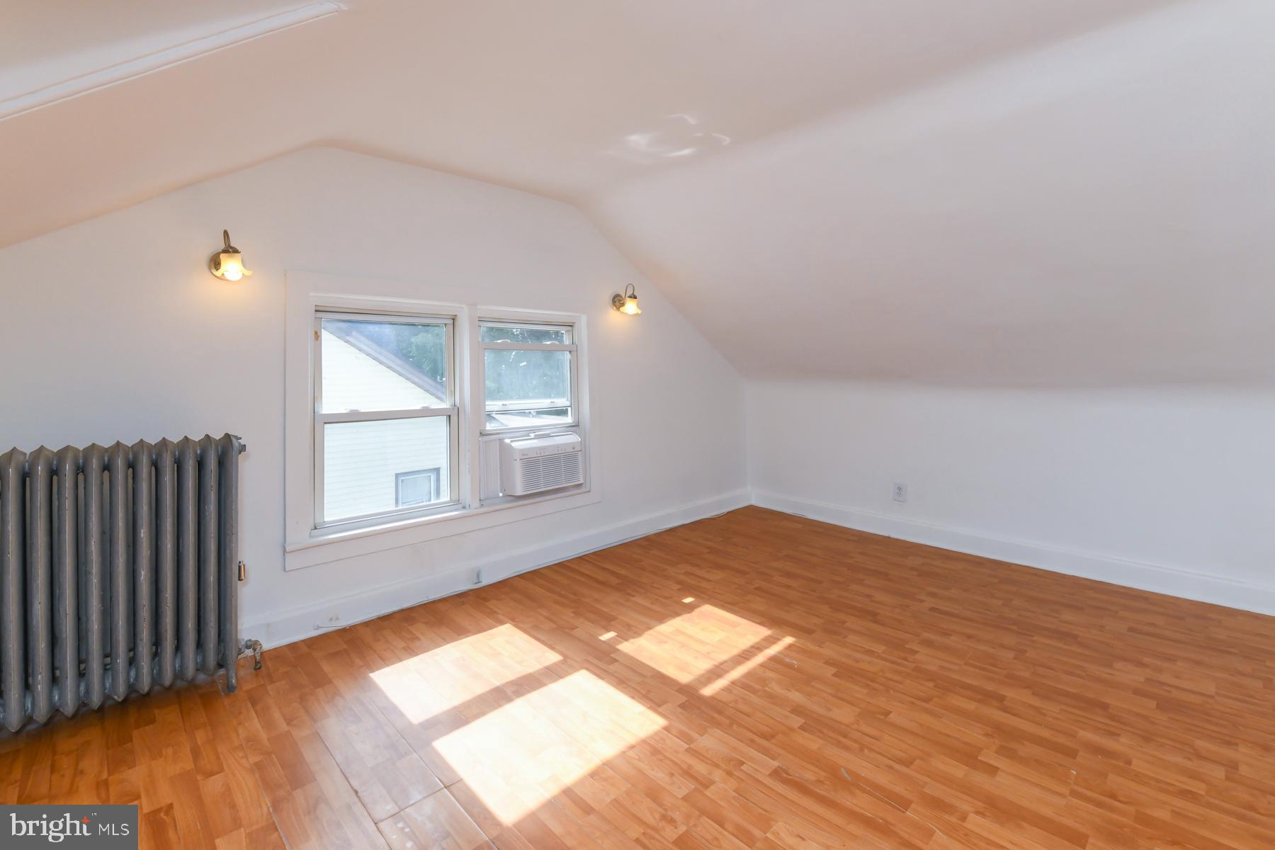 53 High Street, Unit 3A Woodbury, NJ 08096 - Photo 8 of 9 an empty room with wooden floor and windows