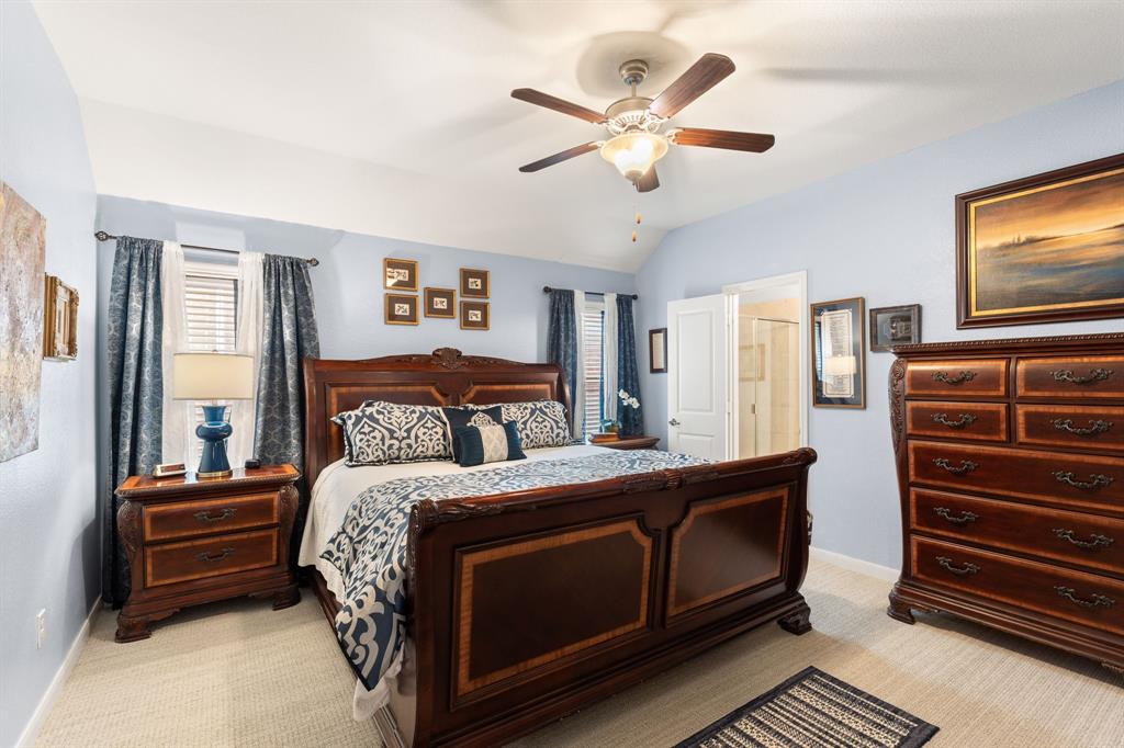 300 Copper Switch Drive Anna, TX 75409 - Photo 12 of 26 The Primary bedroom features a ceiling fan with integrated lighting, and light-colored carpeting